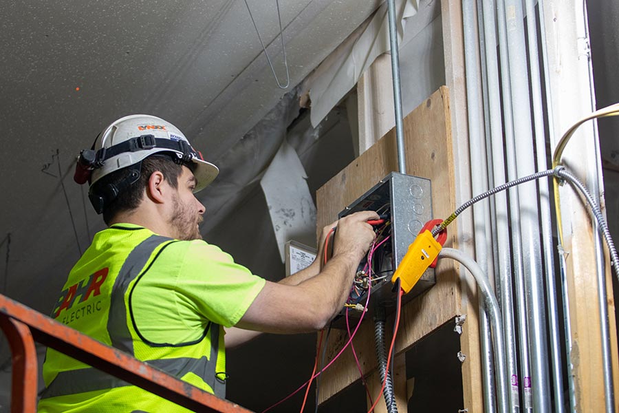 man working on electric panel